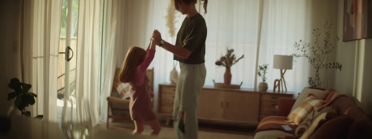 Mother and daughter play together in living room