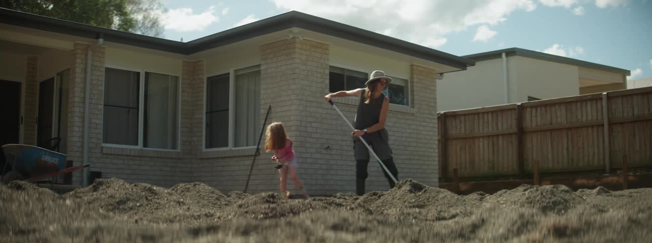 A woman and child are working in the yard