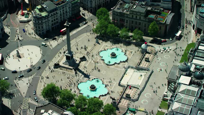 Orbiting aerial view of the obelisk on trafalgar square in london