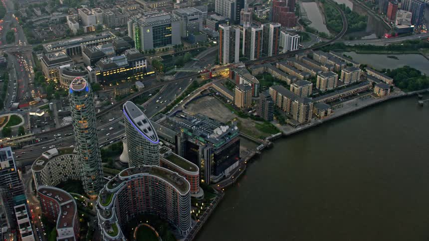 Traffic moves along network of highways near buildings on the waterfront