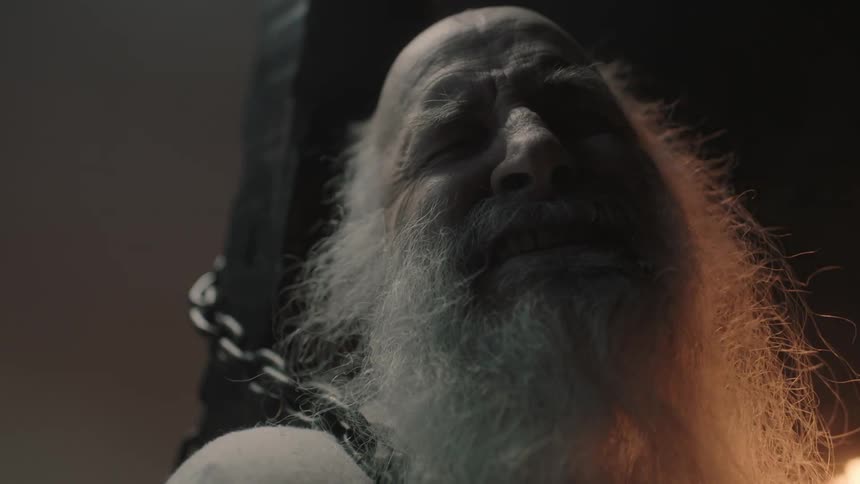 A man is chained and screaming