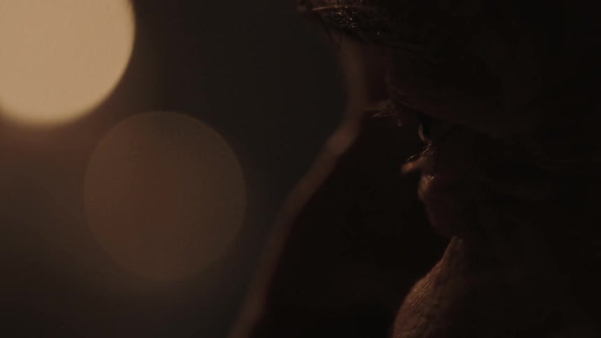 A man looks around in a dark area
