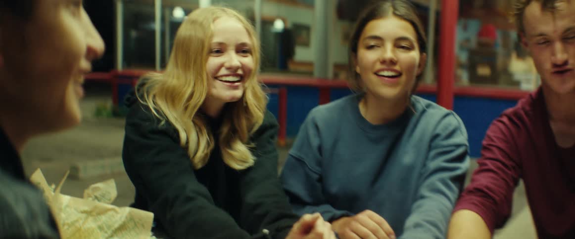 Friends play a game outside of a diner