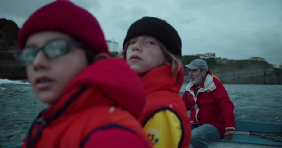 Two boys take in the view while riding on a boat