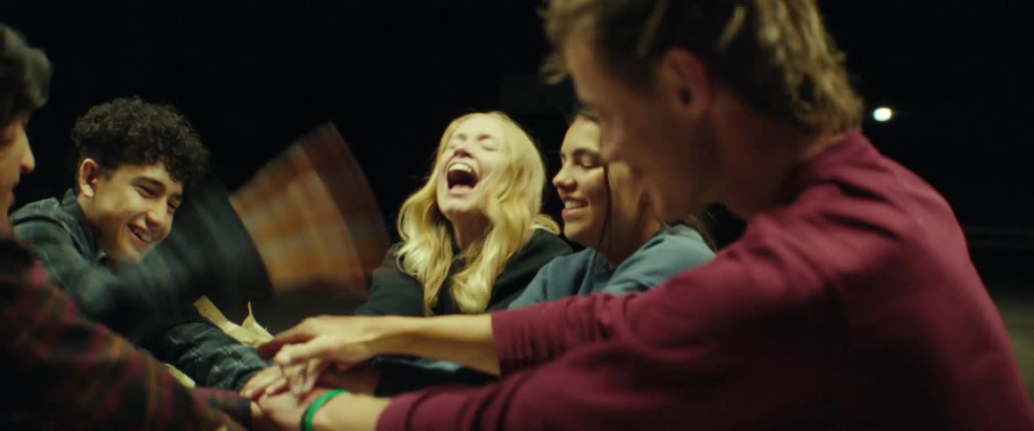 A group of friends play a game outside