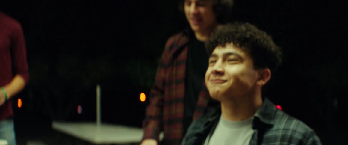 Teenage boys throwing food and catching it with their mouths while goofing around