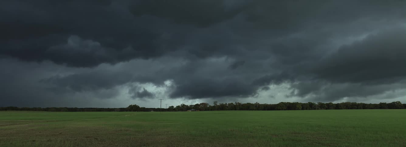 Grey rolling clouds over a field