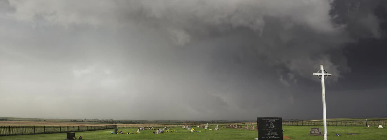 A tornado forming over a grassy field