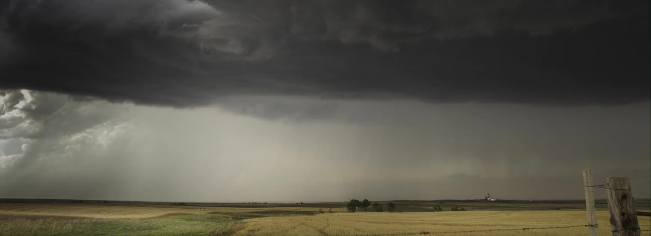 Dark stormy clouds forming over flat plains