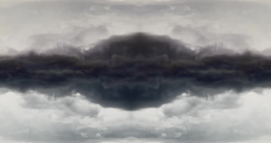 Dark storm clouds rolling together against a lighter sky