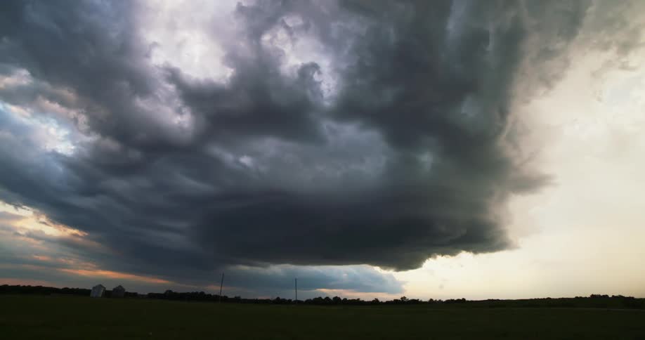 Dark storm clouds form over a field