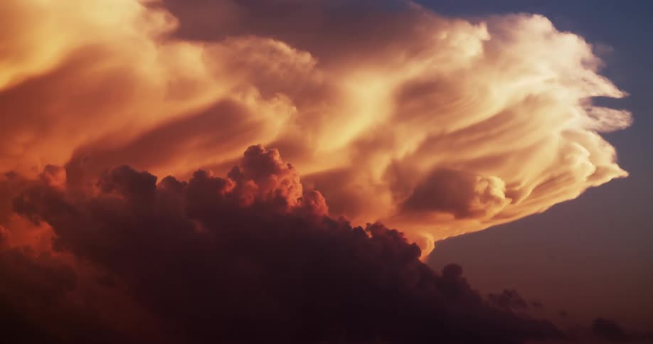 Dense clouds move through the sky at daybreak