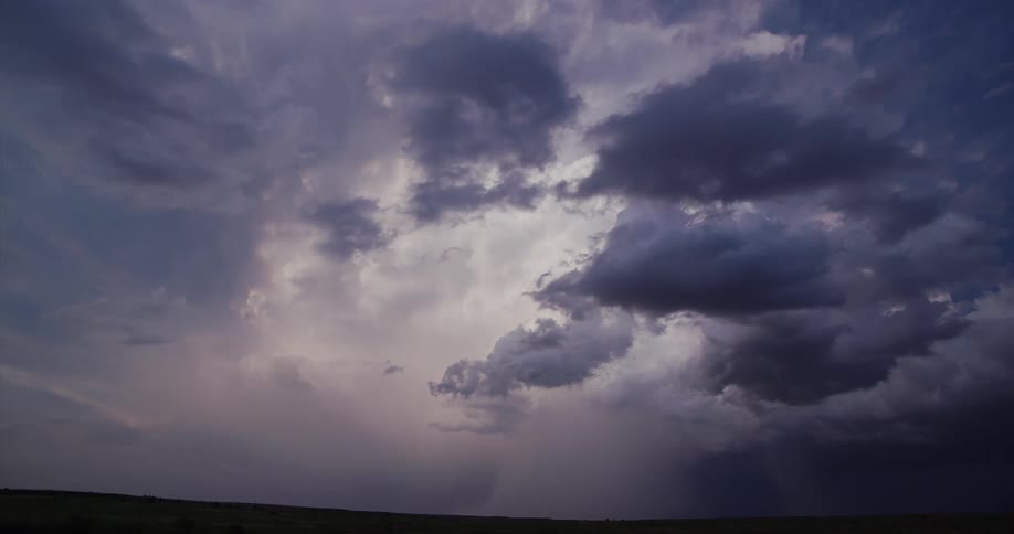 Lightning strikes through dark dense clouds