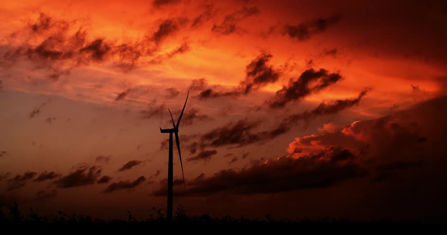 A view of a sunset near a windmill