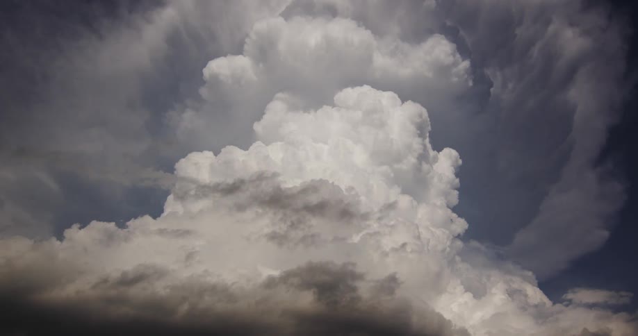 Time lapse of a dramatic cloud formation billowing on the blue sky