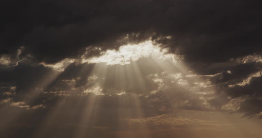 Sunbeams shining through a pocket in a dark cloud