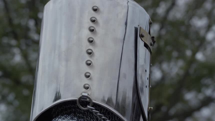 A knight with his metal helmet on
