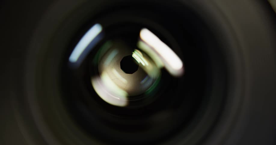 Extreme close up of a camera lens aperture mechanism opening and closing