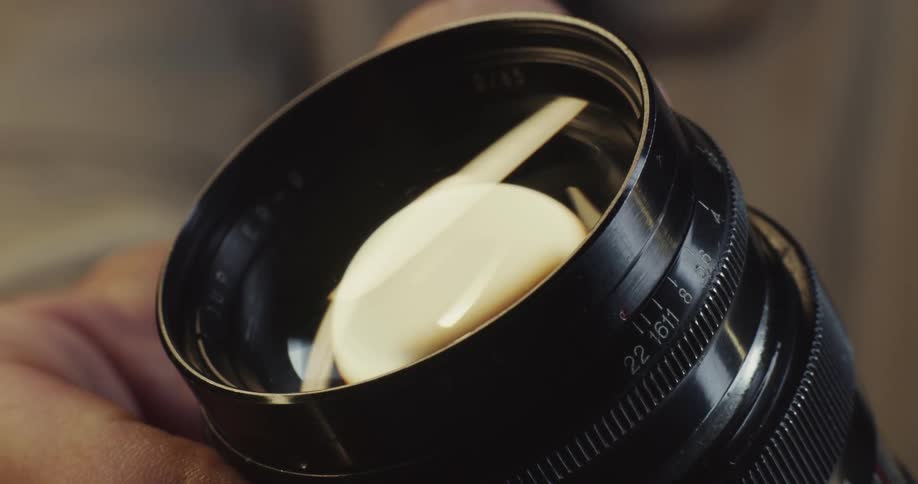 Closeup of persons hand adjusting camera lenses