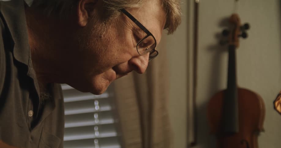 A man is leaning forward looking at something