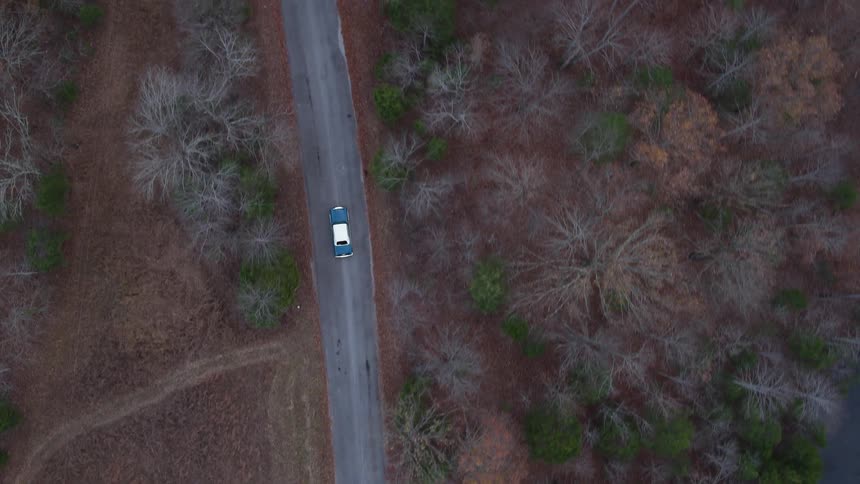 A white topped car drives down a road