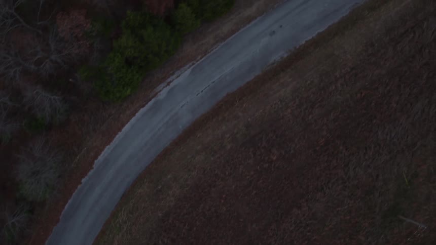 A road is surrounded by grass and trees