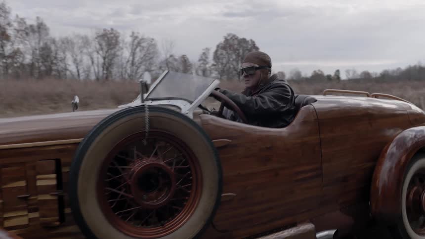 Man driving an old car