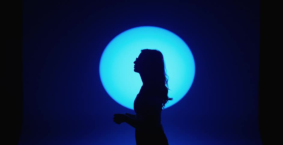 Female models black silhouette against the spotlight in the studio