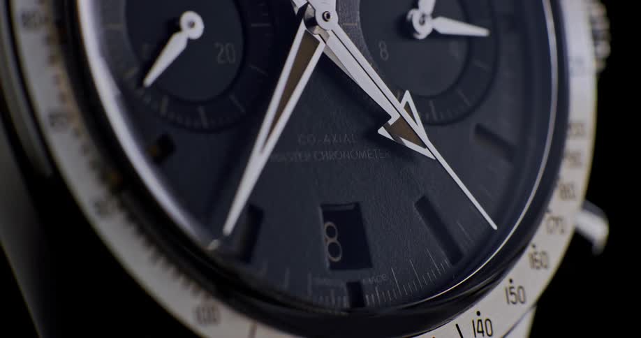 Close up of clock arms moving on the dial of a luxury wristwatch