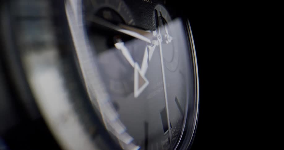 Closeup of silver wristwatch with second hand minute hand and hour hand