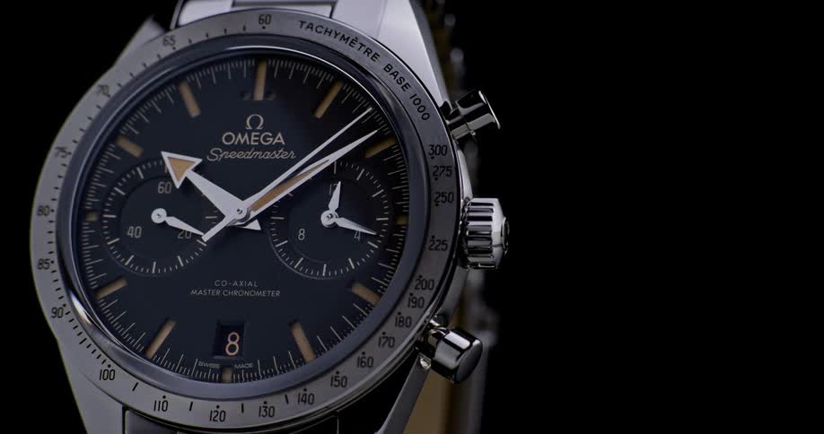 A studio product shot of a wristwatch with a black background