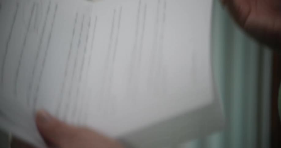 Person holds summit keynote paper while gesturing