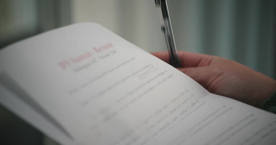 A woman shakes her pen nervously as she edits a keynote address she will give