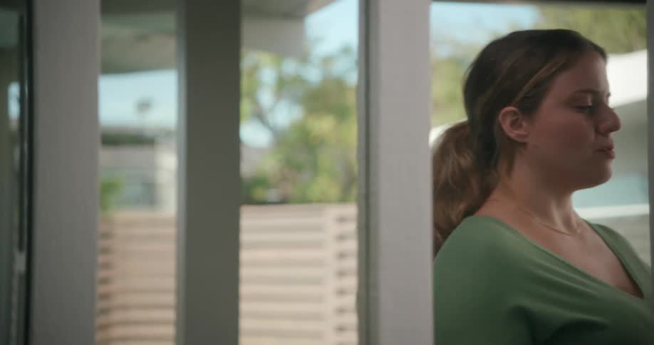 A woman paces back and forth at home as she practices a speech