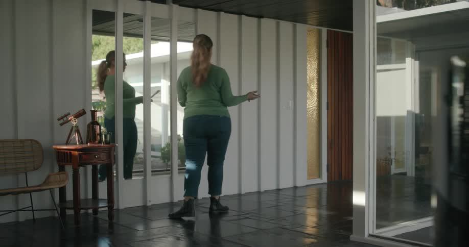 A woman paces back and forth while rehearsing lines from a script