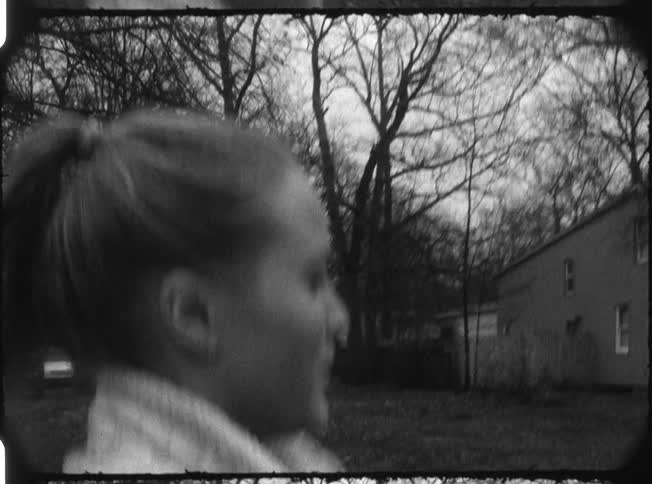 A woman jogs in a residential area