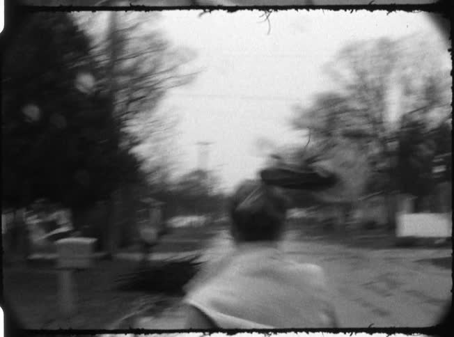 A woman is running down a neighborhood street
