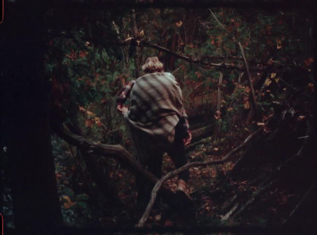 Two people hike along a stream together