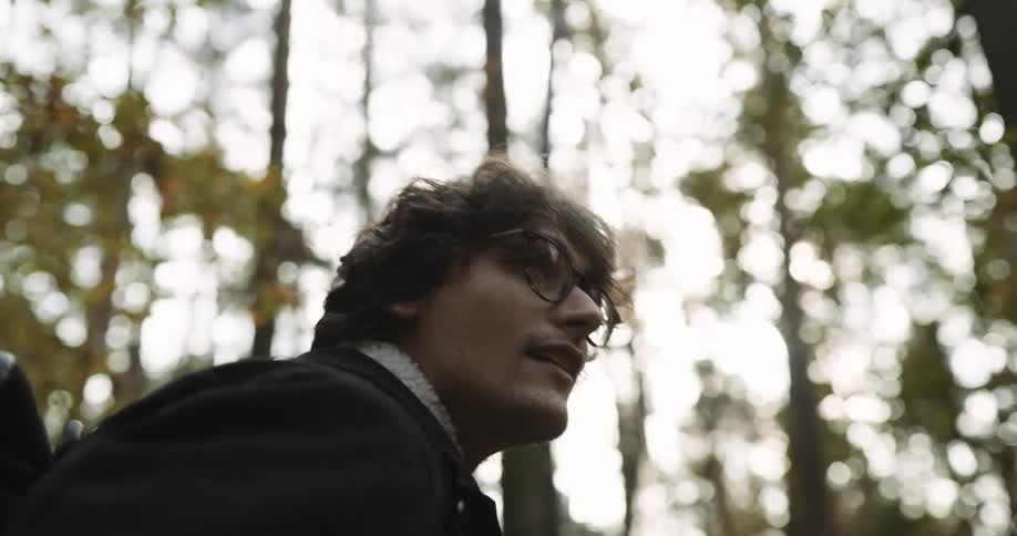 A man is hiking in the forest
