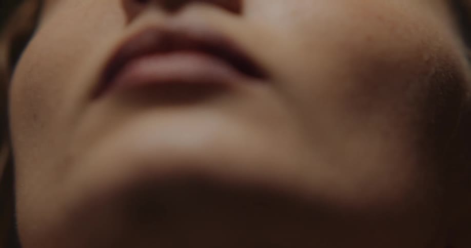 Close up view of a womans face is displayed