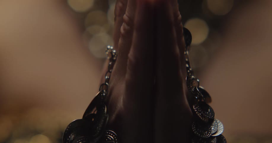 An up close of jewelry on a persons hands they then moves their hands