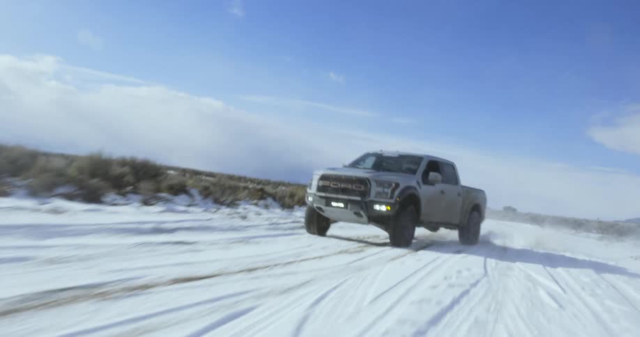 A car is driving off road in the winter season