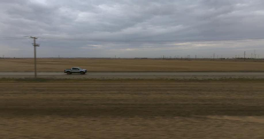 A person is driving a truck through a rural area