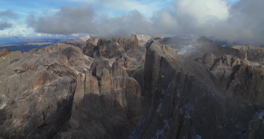 An aerial view of a rocky mountain range in the wilderness on a cloudy day