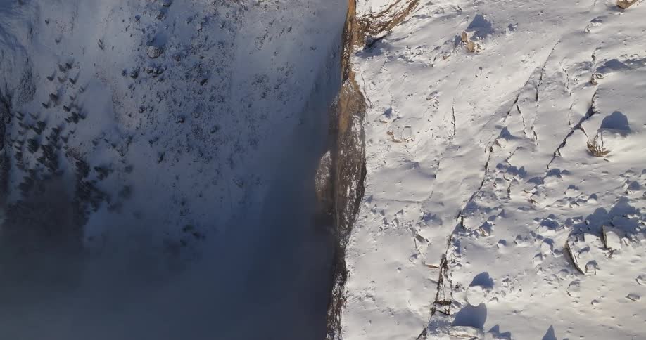 Snow covered mountains are displayed in slow motion