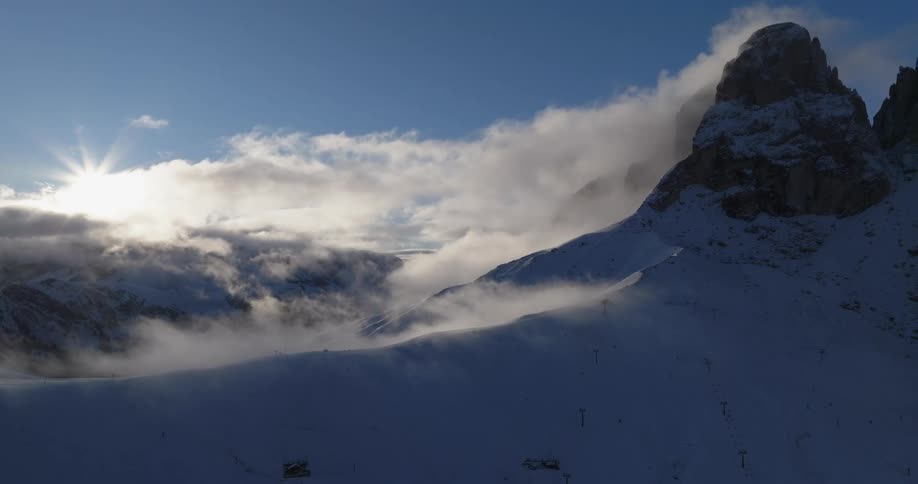 The view is of a cliff that is covered with snow in the winter time