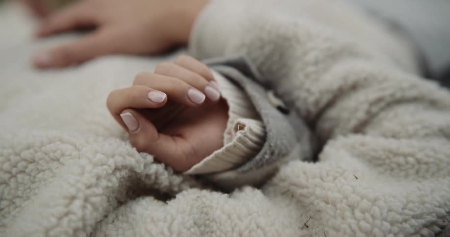People wearing sweaters recline together