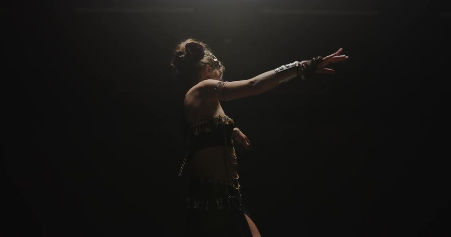 A young white woman is dancing and moving her body