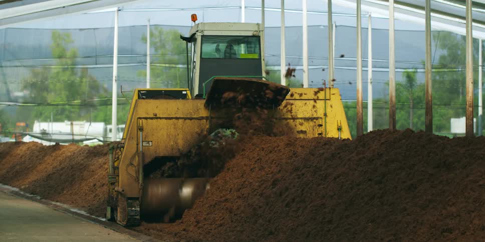 The machine is throwing the dirt into piles