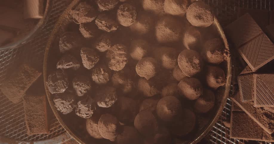 Close up of chocolate balls and cocoa powder in bowl